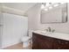 Traditional bathroom featuring a dark wood vanity, white countertops, and a combined tub and shower at 1875 Ebenezer Sw Rd, Conyers, GA 30094