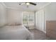 Cozy bedroom with a window, closet and wood floors, creating a serene and comfortable space at 1875 Ebenezer Sw Rd, Conyers, GA 30094