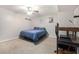 Neutral bedroom with a ceiling fan, wall art, and a cozy bed with a blue comforter at 1875 Ebenezer Sw Rd, Conyers, GA 30094