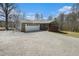 Charming single-story home featuring a stone facade and a spacious driveway leading to an attached two-car garage at 1875 Ebenezer Sw Rd, Conyers, GA 30094