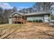 Ranch-style home with a wooden deck and a well-maintained lawn at 1875 Ebenezer Sw Rd, Conyers, GA 30094