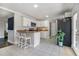 Bright kitchen with white cabinetry, stainless steel appliances, and a breakfast bar with two chairs at 1875 Ebenezer Sw Rd, Conyers, GA 30094