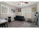 Cozy living room with a leather sofa, hardwood floors, and natural light from two windows at 1875 Ebenezer Sw Rd, Conyers, GA 30094