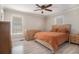 Relaxing bedroom features two windows, wooden floors, ceiling fan, and closet at 1875 Ebenezer Sw Rd, Conyers, GA 30094