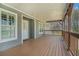 Inviting covered porch with wood decking and railing, perfect for outdoor relaxation and enjoying the surrounding views at 1875 Ebenezer Sw Rd, Conyers, GA 30094