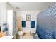 Bright bathroom with patterned shower curtain, tile floors, ample storage, and a toilet at 230 E Ponce De Leon Ave # 327, Decatur, GA 30030