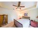 Spacious bedroom featuring neutral walls, carpeted floors, ceiling fan, and classic wooden furniture at 230 E Ponce De Leon Ave # 327, Decatur, GA 30030