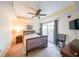 Cozy bedroom with a tray ceiling, a ceiling fan, and a large window allowing natural light at 230 E Ponce De Leon Ave # 327, Decatur, GA 30030