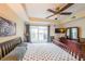 Comfortable bedroom featuring neutral walls, a ceiling fan, and a classic wooden dresser and TV at 230 E Ponce De Leon Ave # 327, Decatur, GA 30030