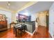 Open kitchen view with cherry cabinets, dark granite countertops, and a breakfast bar with dining area at 230 E Ponce De Leon Ave # 327, Decatur, GA 30030