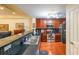 Modern kitchen with stainless steel appliances, breakfast bar, dark countertops, and hardwood floors, open to living area at 230 E Ponce De Leon Ave # 327, Decatur, GA 30030