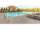 Outdoor pool area with lounge chairs, lush greenery, and resort-style amenities at 230 E Ponce De Leon Ave # 327, Decatur, GA 30030