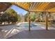 Backyard pool view with a wooden pergola, surrounded by trees at 695 Old Peachtree Rd, Lawrenceville, GA 30043