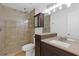 Bathroom featuring a glass enclosed shower with tile surround and a granite countertop sink at 695 Old Peachtree Rd, Lawrenceville, GA 30043