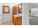 Bathroom featuring a wooden vanity with a granite countertop and mirror at 695 Old Peachtree Rd, Lawrenceville, GA 30043