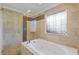 Luxurious bathroom featuring a separate tub and shower with decorative tile at 695 Old Peachtree Rd, Lawrenceville, GA 30043