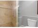 Modern bathroom featuring a tiled shower with glass door and built-in shelving at 695 Old Peachtree Rd, Lawrenceville, GA 30043