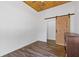Bedroom with a modern sliding barn door and high wood ceilings at 695 Old Peachtree Rd, Lawrenceville, GA 30043