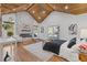 Sunlit bedroom showcasing wood floors, a stone fireplace, and a wood-clad vaulted ceiling at 695 Old Peachtree Rd, Lawrenceville, GA 30043