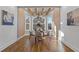 Bright dining room featuring hardwood floors, wood beam accents, and a large bay window with beautiful views at 695 Old Peachtree Rd, Lawrenceville, GA 30043