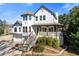 Two-story home with front-facing gables, prominent front tower, landscaped yard and multi-level front entry staircase at 695 Old Peachtree Rd, Lawrenceville, GA 30043