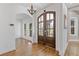 Foyer featuring wood floors, arched entryways, modern lighting, and a double front door at 695 Old Peachtree Rd, Lawrenceville, GA 30043