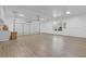 Spacious garage with light hardwood floors, a window for natural light, and overhead storage at 695 Old Peachtree Rd, Lawrenceville, GA 30043