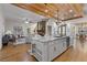 Open concept kitchen with an island, marble countertops, wood ceiling, and views into the living area at 695 Old Peachtree Rd, Lawrenceville, GA 30043