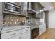 Modern kitchen featuring stainless steel appliances, gray cabinets, and a stylish backsplash at 695 Old Peachtree Rd, Lawrenceville, GA 30043