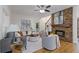 Cozy living room with a stone fireplace, hardwood floors, and comfortable seating at 695 Old Peachtree Rd, Lawrenceville, GA 30043