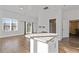 Bright and airy living space featuring a granite island and backyard access at 695 Old Peachtree Rd, Lawrenceville, GA 30043