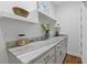 Butler's pantry area featuring a countertop, storage cabinets, decor, and floating shelves at 695 Old Peachtree Rd, Lawrenceville, GA 30043