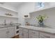 Pantry featuring white cabinets, granite countertop, shelving, and ample storage space at 695 Old Peachtree Rd, Lawrenceville, GA 30043