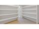 Walk-in pantry with rows of white shelving providing ample storage at 695 Old Peachtree Rd, Lawrenceville, GA 30043