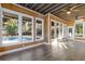 Inviting sunroom featuring wood paneling, ceiling fans and tiled floors, perfect for relaxation overlooking the pool at 695 Old Peachtree Rd, Lawrenceville, GA 30043