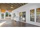 Bright sunroom with white cabinets, ceiling fan, and access to both the screened porch and living area at 695 Old Peachtree Rd, Lawrenceville, GA 30043