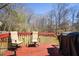 Relaxing back deck area with chairs and grill, overlooking the backyard at 710 Josh Ln, Lawrenceville, GA 30045