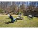 Spacious backyard with a stone fire pit and Adirondack chairs, ideal for gatherings at 710 Josh Ln, Lawrenceville, GA 30045