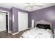 This bedroom features gray wood-look flooring, purple walls, white trim, and a white comforter decorated with Eiffel Towers at 710 Josh Ln, Lawrenceville, GA 30045