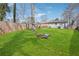 Large, grassy backyard with a fire pit area and a wood privacy fence at 2518 Crestdale Se Cir, Atlanta, GA 30316