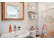 Colorful bathroom with a rainbow shower curtain, sink, and decorative items at 2518 Crestdale Se Cir, Atlanta, GA 30316