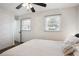 A well-lit bedroom with hardwood floors, two windows, and a closet for storage at 2518 Crestdale Se Cir, Atlanta, GA 30316