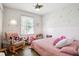 Cozy bedroom with pink accents, featuring a window and playful decor at 2518 Crestdale Se Cir, Atlanta, GA 30316