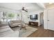 Bright living room with hardwood floors, a ceiling fan, and large windows at 2518 Crestdale Se Cir, Atlanta, GA 30316