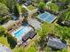 Aerial view of the community pool, playground, and tennis courts surrounded by mature trees at 745 Princeton Mill Run, Marietta, GA 30068