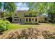 The back of the house overlooking a large backyard with lawn and wooded area at 745 Princeton Mill Run, Marietta, GA 30068