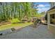 Beautiful backyard with a patio, green grass, mature trees, and a wooden fence at 745 Princeton Mill Run, Marietta, GA 30068