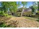 A well-maintained backyard featuring a lush lawn, a two-story home and a sunroom at 745 Princeton Mill Run, Marietta, GA 30068
