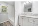 Modern bathroom features a tub, shower, and single vanity with sleek countertops and fixtures at 745 Princeton Mill Run, Marietta, GA 30068