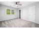 Comfortable bedroom offers neutral colors, a ceiling fan, and natural light from a window at 745 Princeton Mill Run, Marietta, GA 30068